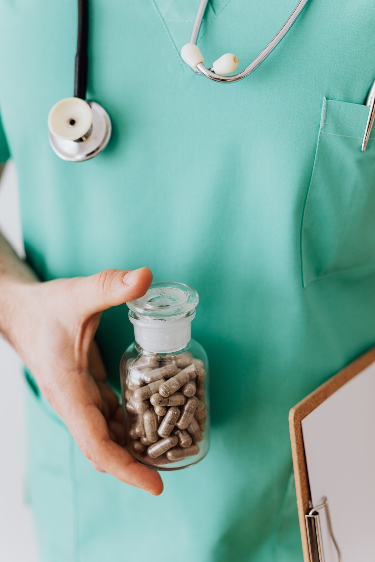 Clinician holding a medicine bottle